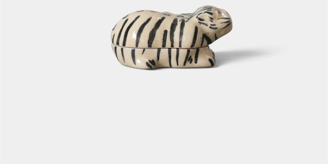 Vintage ceramic tiger kogo with black stripes on an ivory-toned body