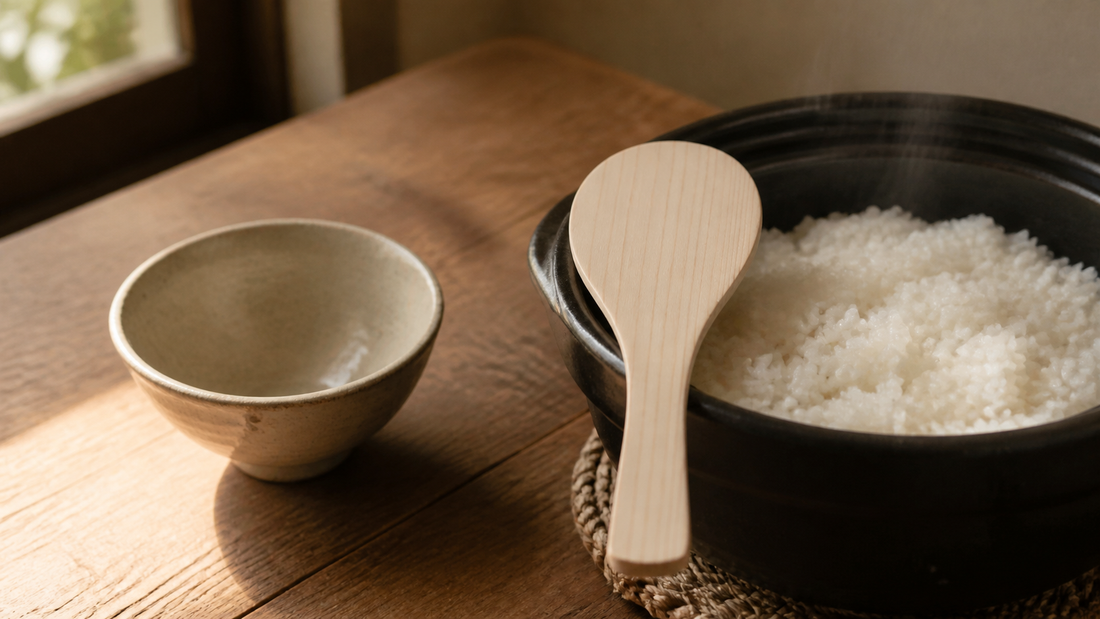 Japanese hinoki wooden rice paddle with freshly cooked rice