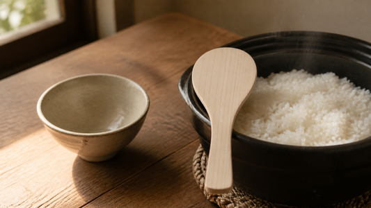 Japanese hinoki wooden rice paddle with freshly cooked rice