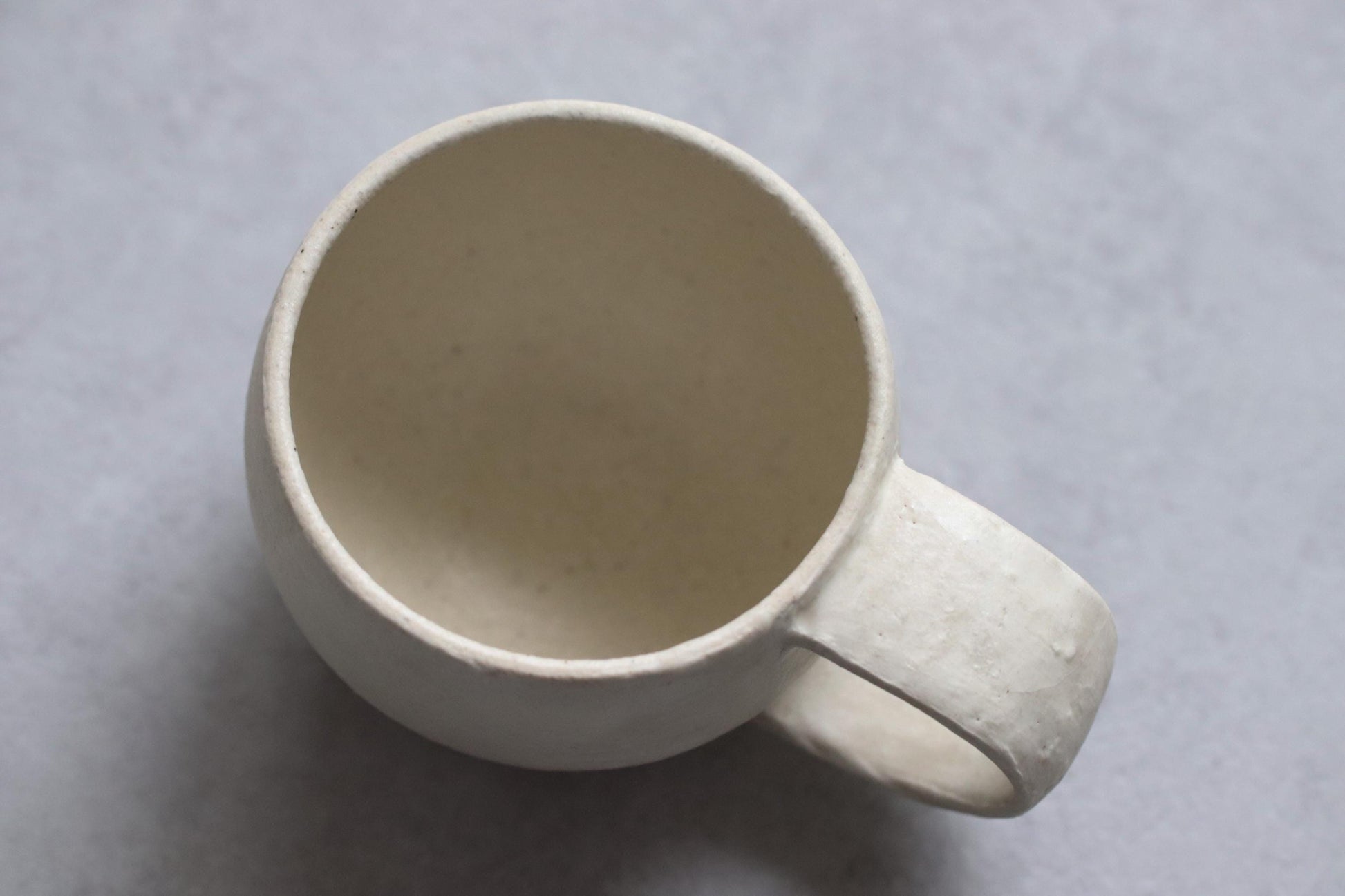 Handcrafted Minimalist White Ceramic Mug by Yukiko Oonakahara | Japanese Pottery | Wabi-sabi Cup