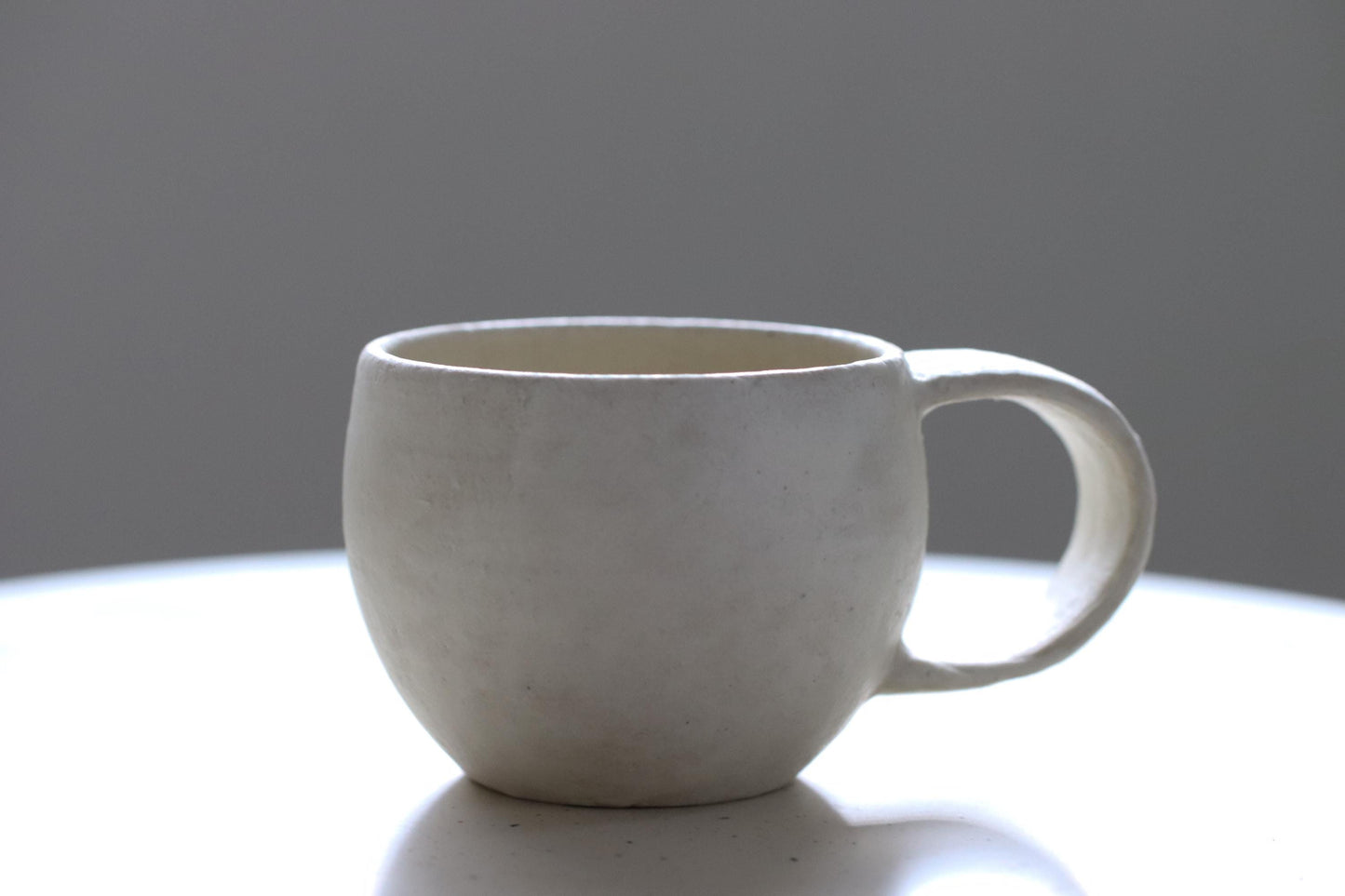 Handcrafted Minimalist White Ceramic Mug by Yukiko Oonakahara | Japanese Pottery | Wabi-sabi Cup