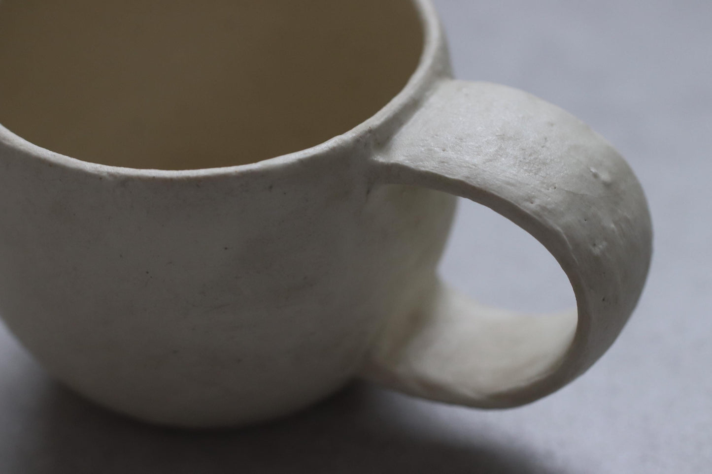 Handcrafted Minimalist White Ceramic Mug by Yukiko Oonakahara | Japanese Pottery | Wabi-sabi Cup