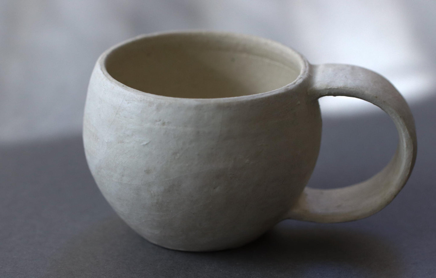 Handcrafted Minimalist White Ceramic Mug by Yukiko Oonakahara | Japanese Pottery | Wabi-sabi Cup